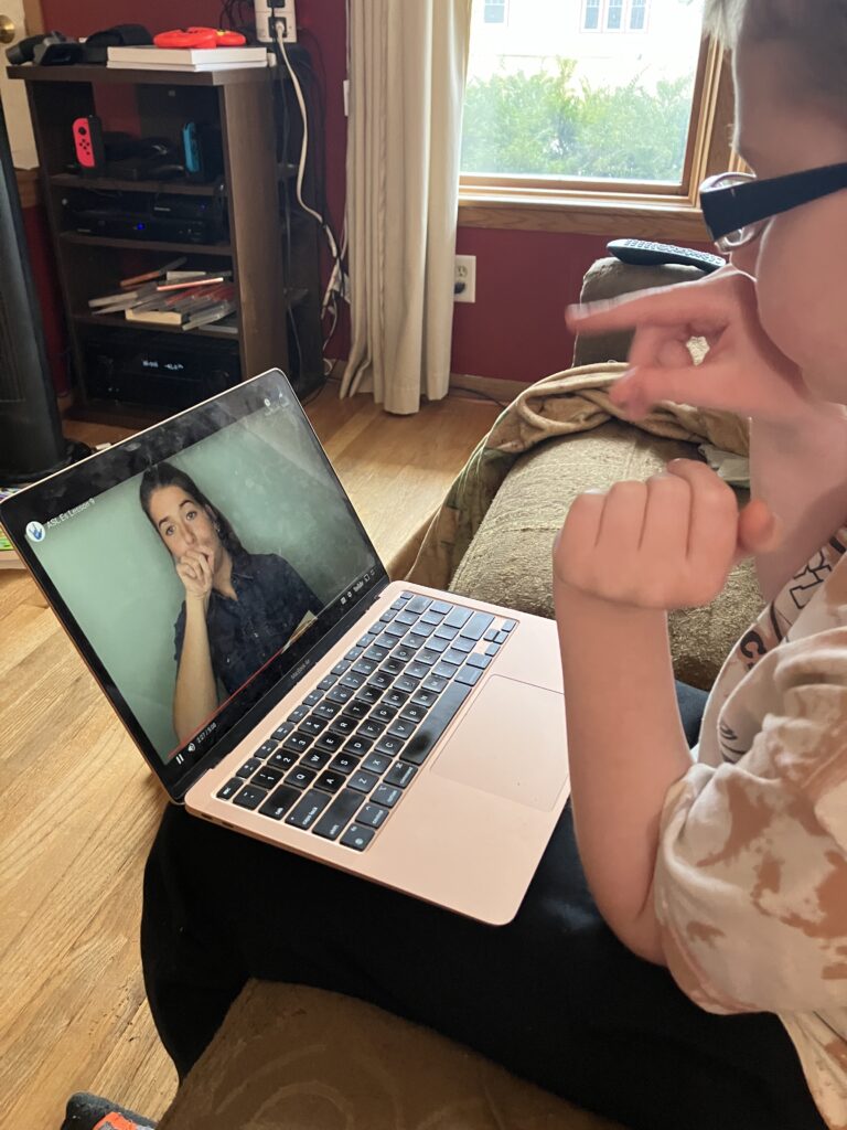 A boy sits on a couch. He is signing bird while following along with his female teacher on a computer signing bird.

Are you hoping for your children to learn ASL in your homeschool? This self-paced ASL 1 class for homeschoolers from Mr. D Math is great!